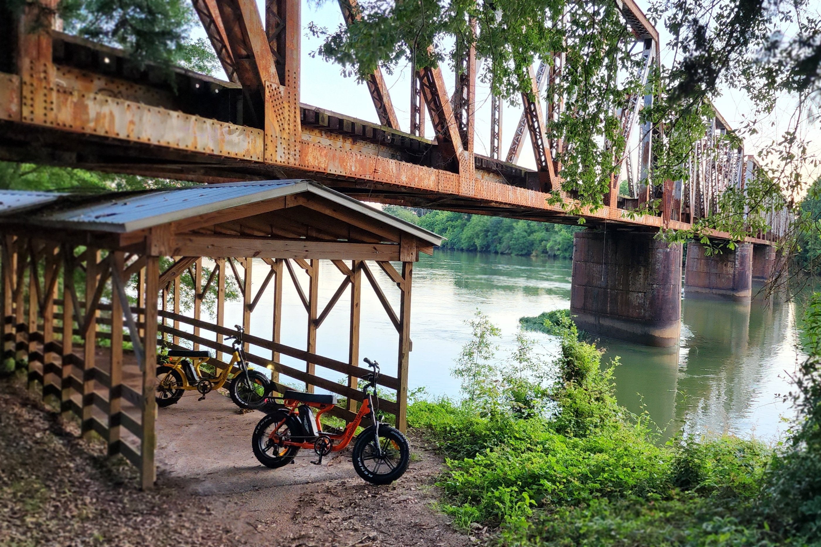 AddMotor M-66 R7 Electric Moped Scooters captured in scenic WestPoint Georgia and positioned against the iconic backdrop of the CSX Viaduct over the Chattahoochee River