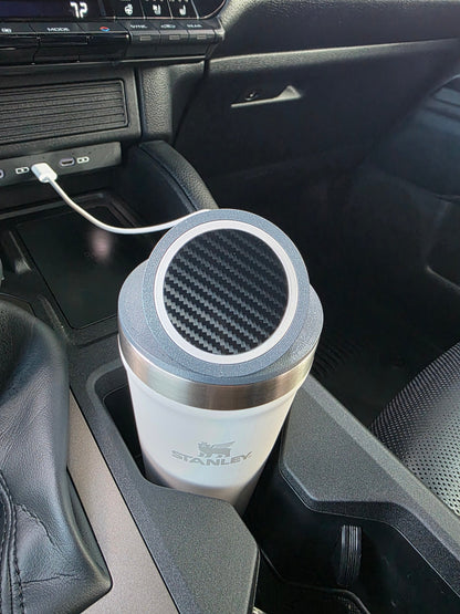 Close-up of the MagSafe stand lid's magnetic pad on a white Stanley 16 oz cup in a truck console