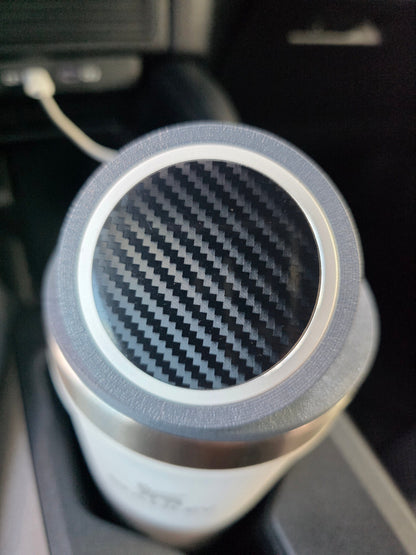Macro view of the MagSafe stand lid's magnetic pad, cup sitting in a truck console