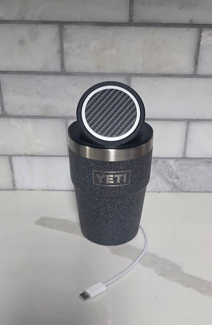 YETI cup with the black MagSafe stand lid tilted up on a kitchen counter, USB-C cable alongside