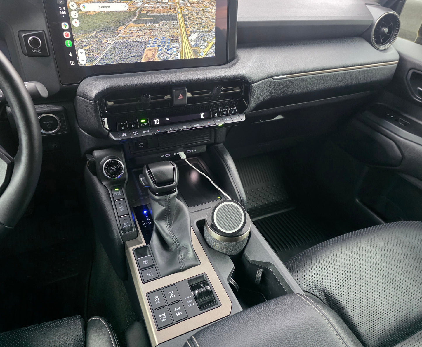 Truck interior with a YETI cup MagSafe stand sitting in the console cupholder