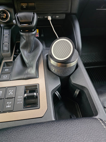 YETI cup with the black MagSafe stand lid in a truck cupholder, cable plugged into the dash port