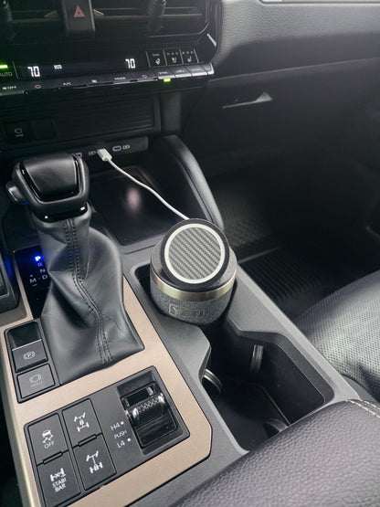 Black MagSafe stand lid tilted up on a YETI cup in a truck console cupholder