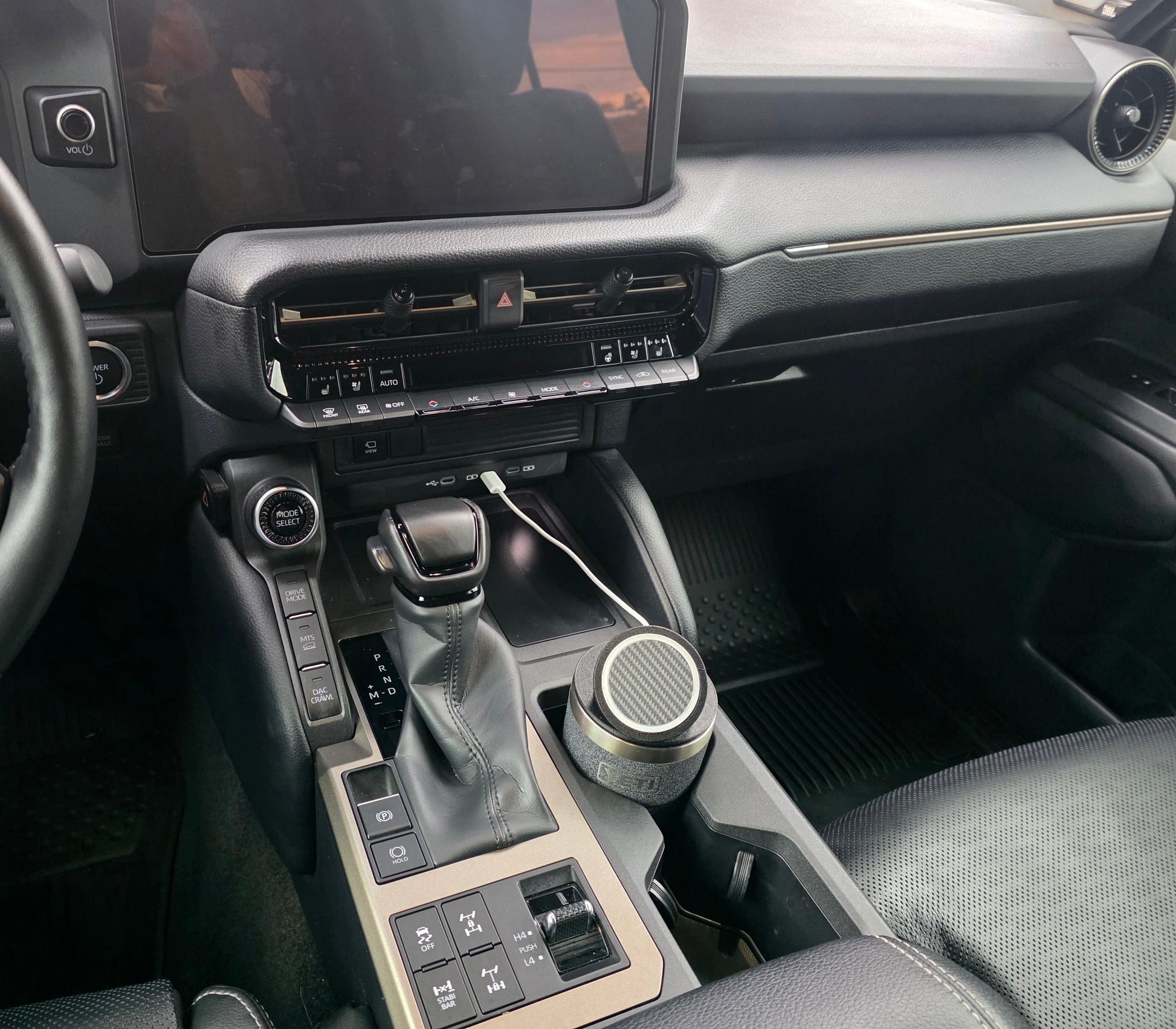 Wide view of a truck cab with a YETI cup MagSafe stand in the console cupholder