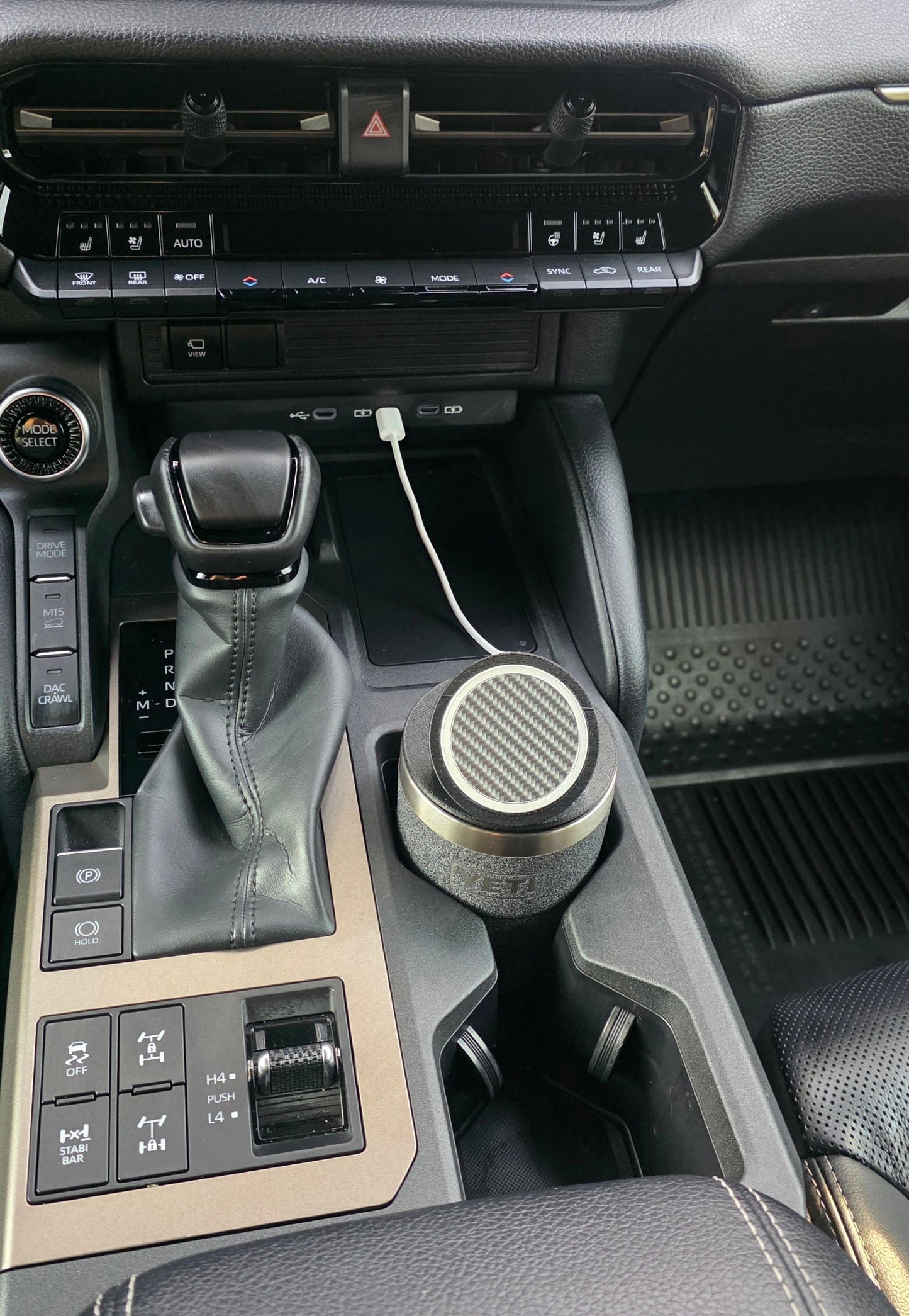 YETI cup MagSafe stand in the console cupholder with the charging cable plugged into the dash