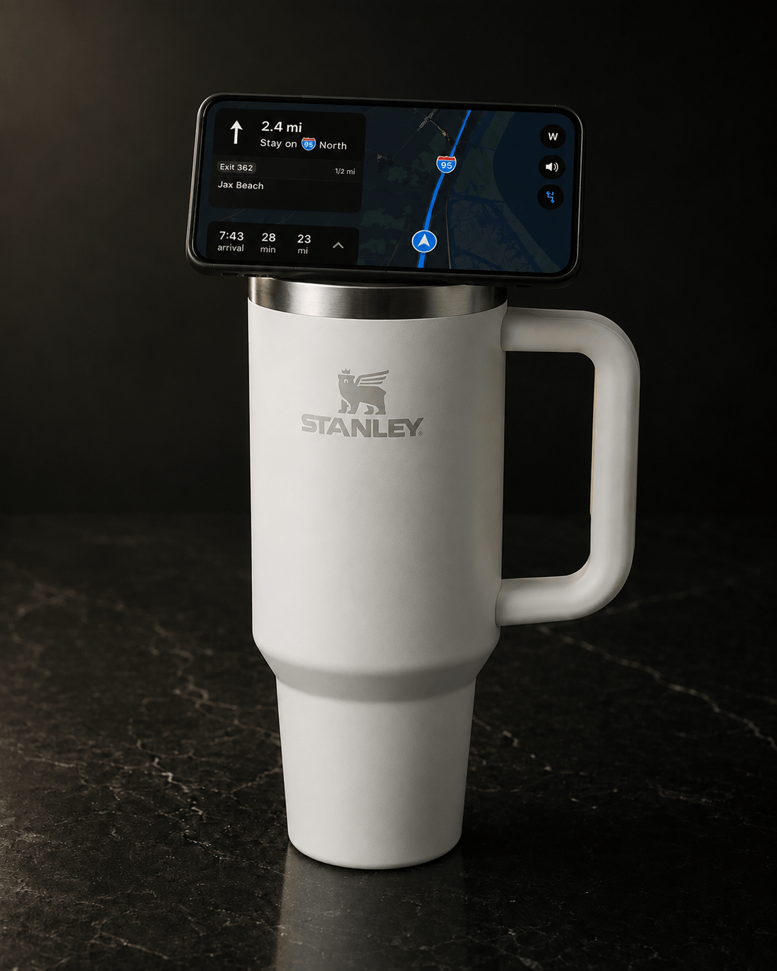 White Stanley Quencher H2.0 40 oz with the NMT MagSafe phone mount lid, iPhone docked in landscape showing navigation