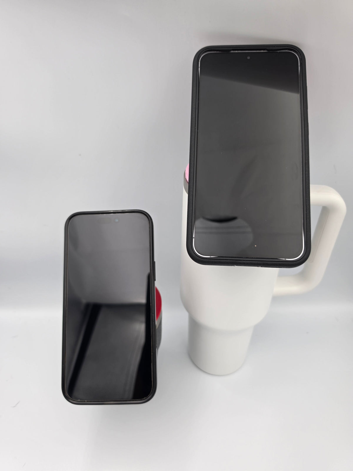 Two tumblers with phones mounted upright in portrait orientation