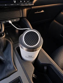 White Stanley Everyday Tumbler with an NMT mount and charging puck fitted in a vehicle cupholder.