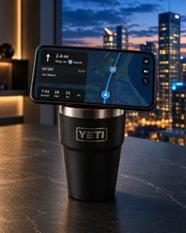Phone docked on an NMT replacement lid fitted to a black YETI cup on a city office desk.